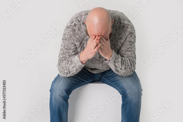 Fototapeta Bold bearded sad man is crying . Isolated. White background