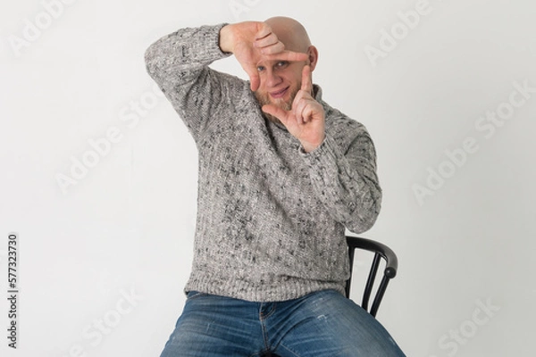 Fototapeta Bolded bearded man in jeans is doing picture frame with his hands