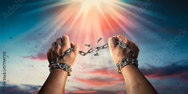 Fototapeta Hands in fists breaking a chain freedom. The concept of gaining freedom.