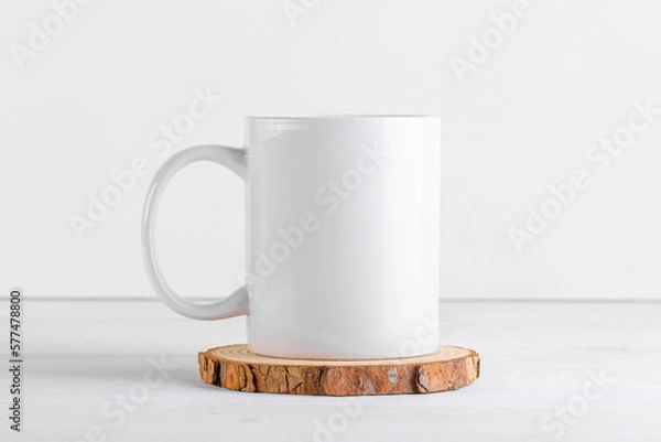 Obraz White mug mockup with blank copy space for your advertising text message or promotional content on a wooden podium on white background. Coffee mug mock up, close up