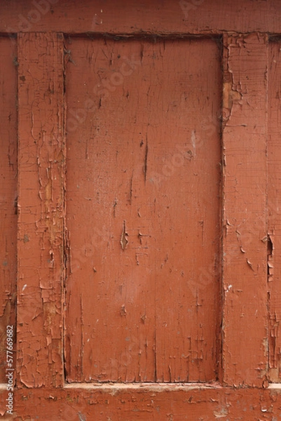 Fototapeta The board is painted orange, close-up. Wood texture. Natural wood background. Old wooden panel, faded and peeling paint. Tree background