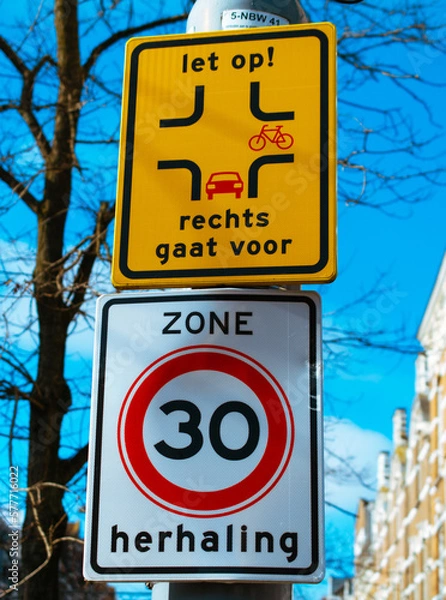 Obraz Nederlands road sign with speed limit zone and pass priority for bicycles. Translation - zone repeat and look out, right goes first