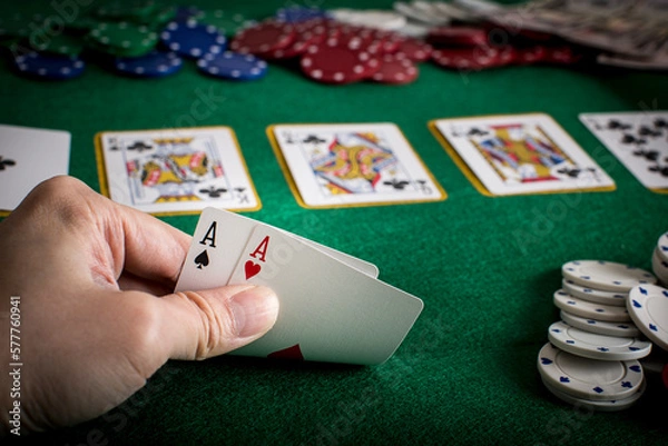 Fototapeta Closeup of hands with two aces, Texas Hold'em Poker gambling concept