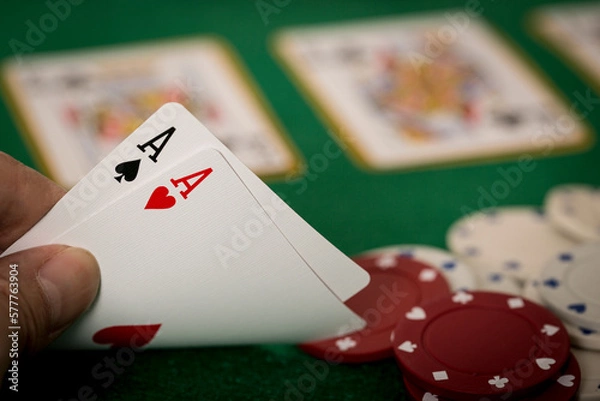 Fototapeta Closeup of hands with two aces, Texas Hold'em Poker gambling concept	
