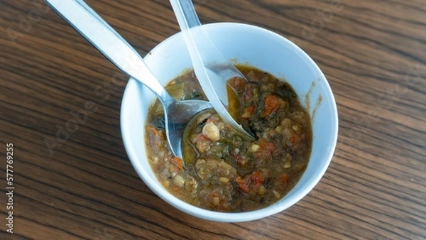 Obraz Sambal oncom or oncom sauce in a white bowl. One of the most popular fermented food in Indonesia or Sunda is oncom