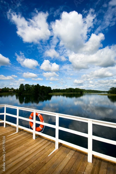 Obraz Orange safe guard ring against sea background