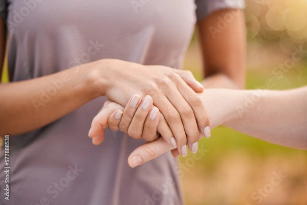 Fototapeta Hands, trust and support with friends outdoor together in a show of unity, solidarity or comfort. Love, empathy and care with a female comforting or consoling a friend outside for compassion