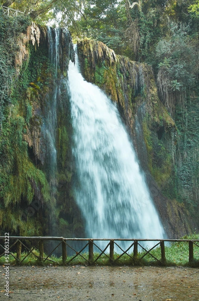 Obraz Waterfall surrounded by lush greenery