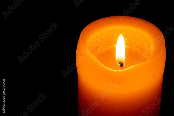 Obraz burning candle on black
