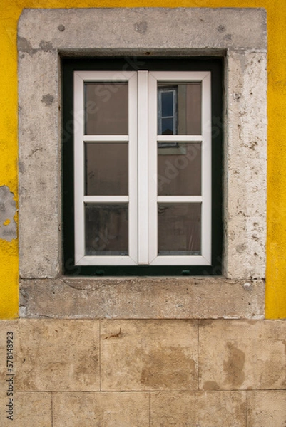 Obraz Wooden exterior window of an old house with a stone facade