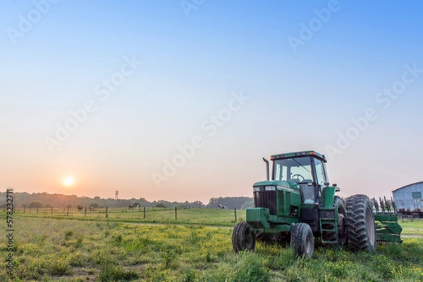 Obraz Tractor in a field on a Maryland farm at sunset