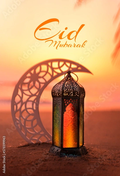 Fototapeta Ramadan lantern and Crescent moon shape on the beach at sunset