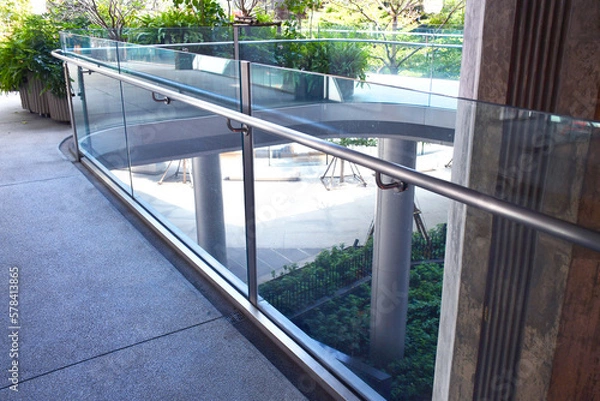 Fototapeta Curve tempered laminated glass railing balustrade panels frame less ,safety glass for modern architectural buildings. Concept for Aluminum balcony or terrace design with glazing profile. 