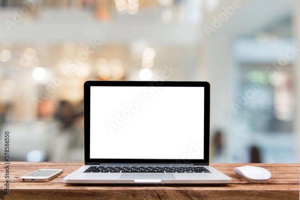 Fototapeta Computer notebook and mouse with a coffee shop behind the scenes Blur coffee shop, Blur restaurant