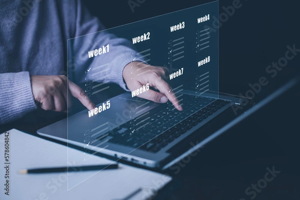 Fototapeta Businessman using a laptop and Taking an assessment, questionnaire, evaluation, online survey online exam Choosing the right answer in exam by filling out the online survey form,Answer  test questions