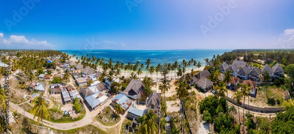 Fototapeta The turquoise ocean water and the luxurious resort on Kiwengwa beach in Zanzibar, Tanzania, are captured in this gorgeous toned aerial view. The scenery is simply stunning, and it's a perfect destinat