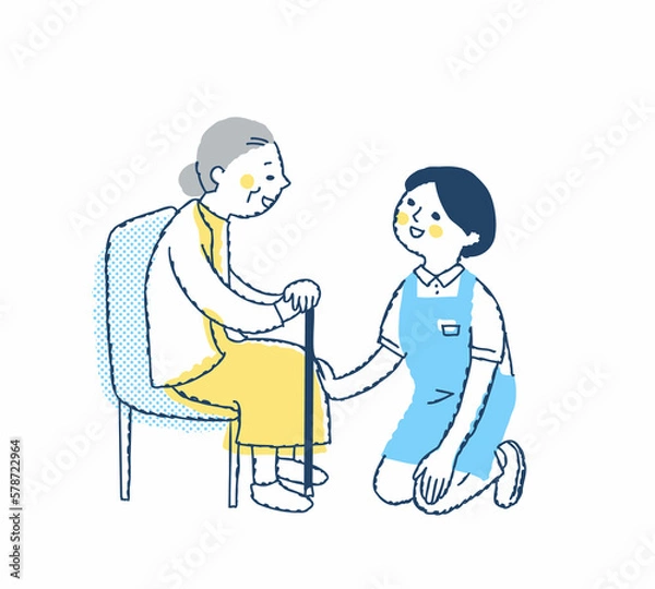 Fototapeta シニア女性としゃがんで話す介護スタッフ