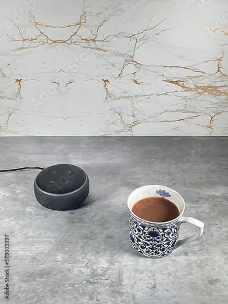 Fototapeta Amazon smart speaker in a clean modern kitchen with a cup of tea.