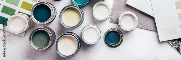 Fototapeta Tiny sample paint cans during house renovation, process of choosing paint for the walls, different green and beige colors, color charts on background, banner size