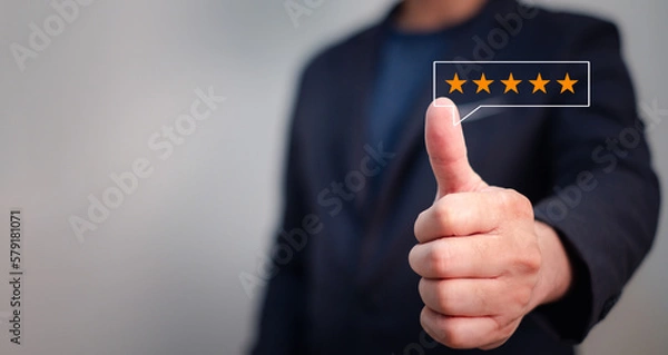 Fototapeta customer satisfaction concept, business man giving thumb up with five stars symbol for positive feed back with satisfied in quality of service