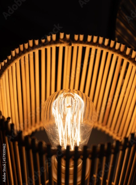 Obraz a wooden lamp shines on the table