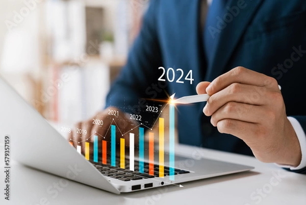 Fototapeta Businessman analyzes profitability of working companies with digital augmented reality graphics, positive indicators in 2024, businessman calculates financial data for long-term investments.