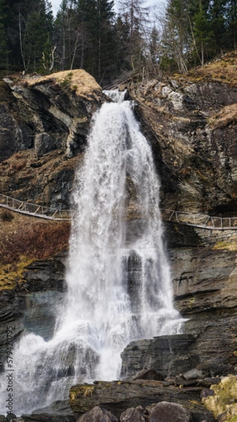 Obraz Small waterfall going down sharp stone cliffs