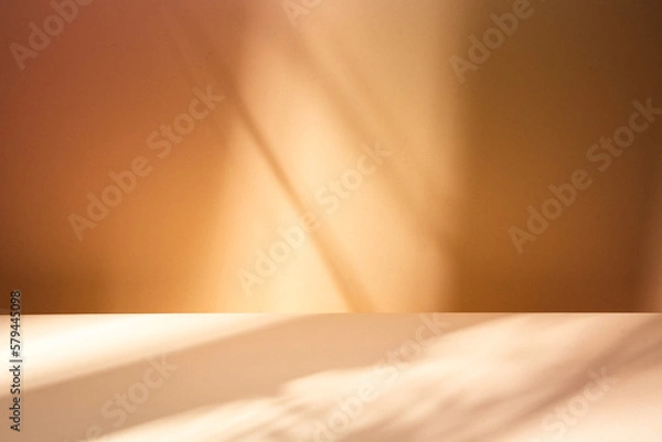Obraz Empty table on brown background with natural shadows on the wall. Mock up for branding products, presentation, food and health care.	
