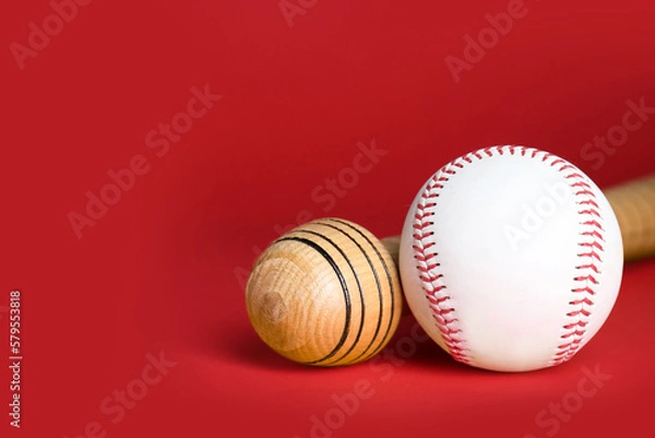Fototapeta Wooden baseball bat and ball on red background, closeup. Space for text
