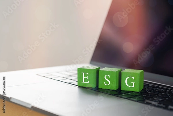 Obraz Wooden cubes with target setting to ESG icon with other ESG icons on computer. Copy space. ESG concept of environmental, social and governance. Sustainable corporation development..