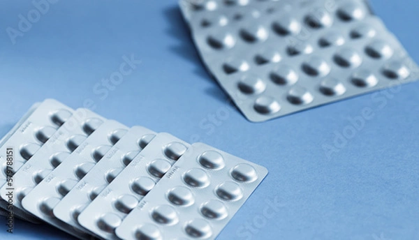 Fototapeta Different blister of pills. Medical healthcare concept. Light blue paper background with copy space.