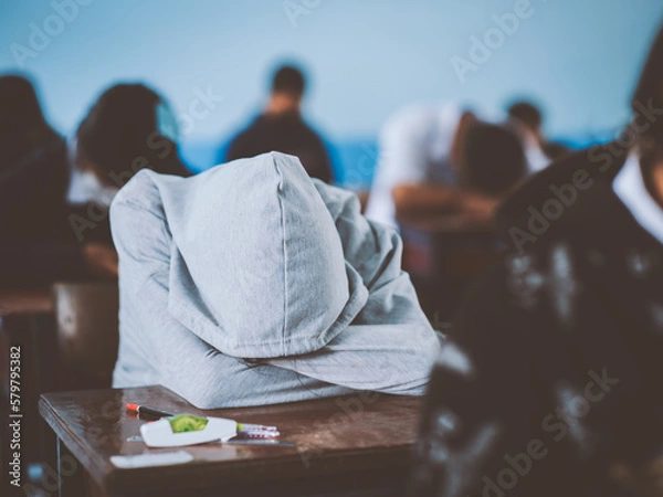 Fototapeta Tired uniform students sleeping in a exam test in classroom with stress
