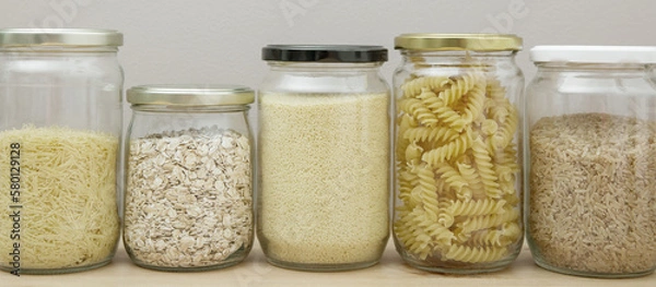 Fototapeta Variety of legumes and grains in glass jars. Concept of zero waste and eco-friendly lifestyle. Domestic life without waste in home and kitchen. No plastic. Web banner