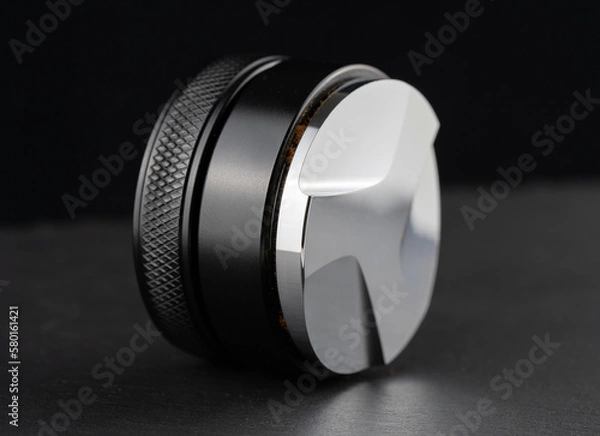 Obraz Coffee leveler with black matte texture and shiny bottom. Barista tool for leveling ground coffee in the porta filter before extraction.