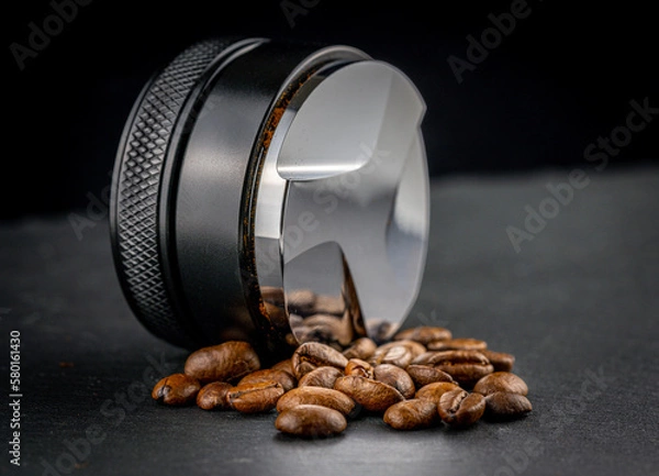 Obraz Coffee leveler with black matte texture and shiny bottom. Barista tool for leveling ground coffee in the porta filter before extraction.