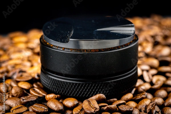 Obraz Coffee leveler with black matte texture and shiny bottom. Barista tool for leveling ground coffee in the porta filter before extraction.