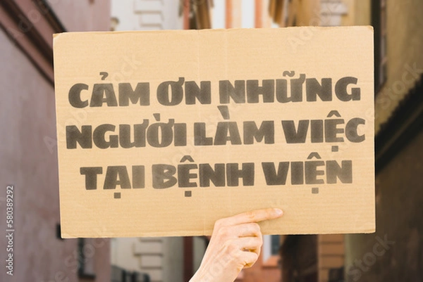 Fototapeta The phrase " Thank you hospital workers " on a banner in hand. The Human holds cardboard with an inscription. Gratitude to healthcare staff. Heroes. People who save lives. Thankfulness. Life