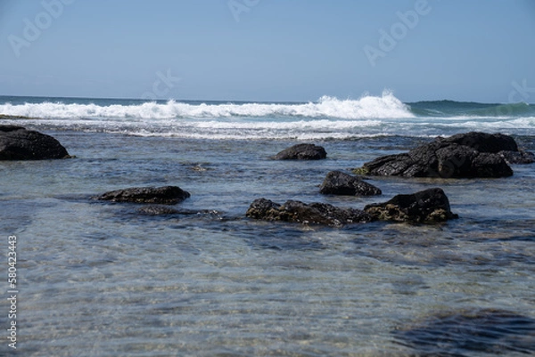 Fototapeta waves breaking on the rocks