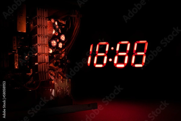 Obraz clock and electronic components on a dark background