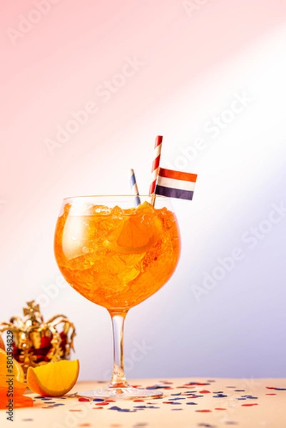 Fototapeta Summer coctail Aperol spritz in glass with Dutch flag and Kings day symbols in background. National holiday Koningsdag on 27 aprilin the Netherlands. Holland culture concept with copy space