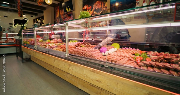 Fototapeta Chops of beef meat on skewers layout in the store. Selection of different cuts of fresh meat raw red in a supermarket.