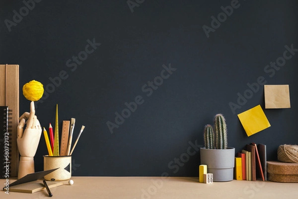 Obraz Creative desk with notebook, desk objects, office supplies, books, and cactus on a dark blue background.	
