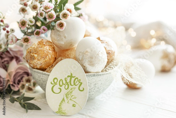 Fototapeta Spring composition with Easter eggs and flowers on a blurred background.