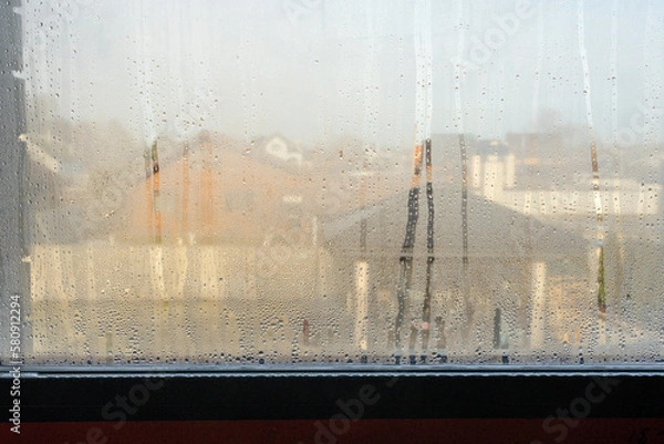 Fototapeta Close up of double glazed window condensation causes by excessive moisture in the house in winter occurs when the seal between panes is broken or desiccant inside the window.