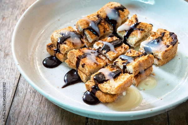Fototapeta whole wheat slice bread toast Topped with chocolate sauce and condensed milk