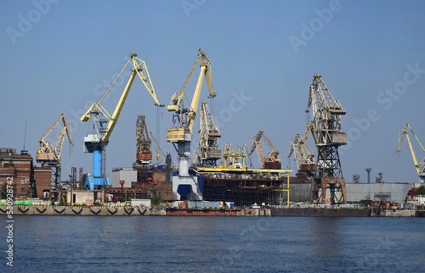 Fototapeta Working cranes in the port city