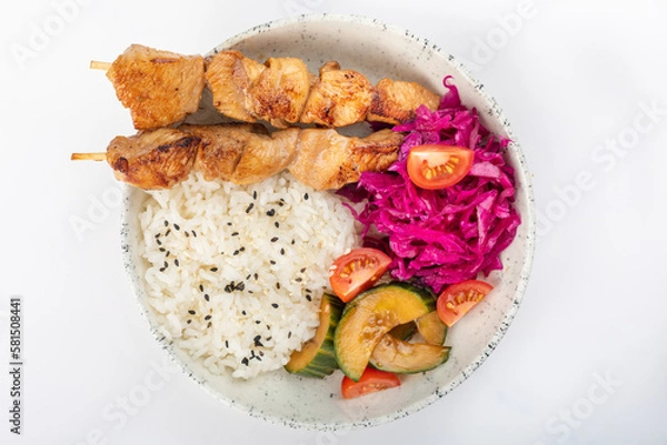 Fototapeta Asian style chicken skewers with black sesame rice, zucchini, cherry tomatoes and red cabbage. On a white background, top view.