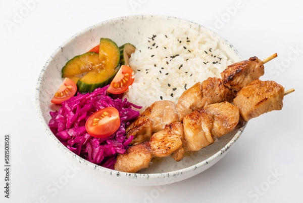 Fototapeta Asian style chicken skewers with black sesame rice, zucchini, cherry tomatoes and red cabbage. On a white background, close up 3/4