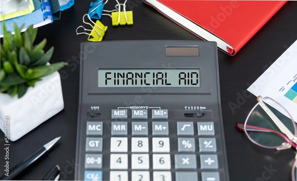 Fototapeta The text FINANCIAL AID written on calculator display on office table.