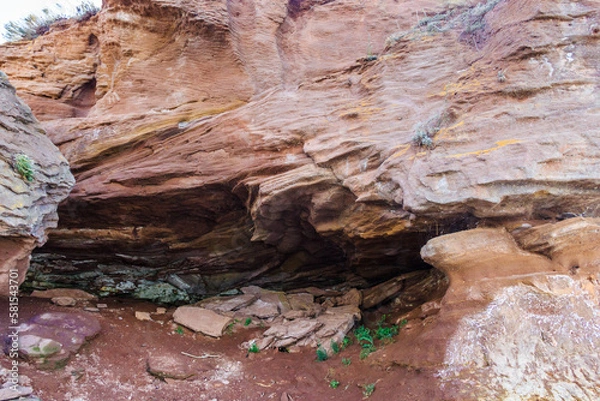 Fototapeta a large rock formation on rocky coastline, wonder of nature. waves in the process of erosion eroded the rock